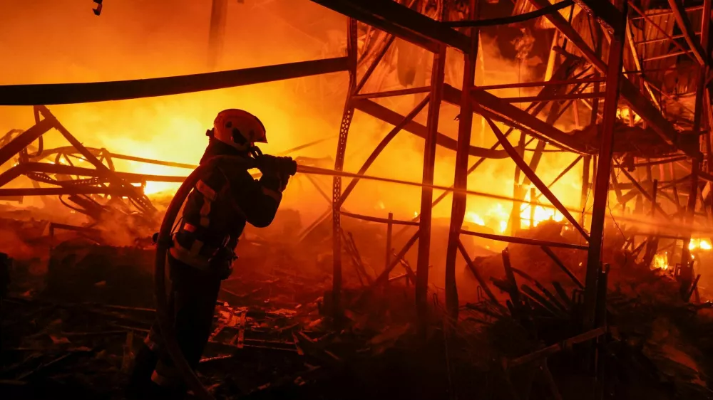 A firefighter works at a compound of a warehouse damaged during Russian missile strikes, amid Russia's attack on Ukraine, in Kyiv, Ukraine July 16, 2026. REUTERS/Valentyn Ogirenko   TPX IMAGES OF THE DAY