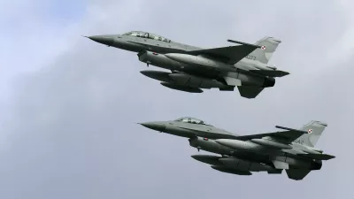 Two of the first four Polish Air Force F-16 fighter jets arrive at the Krzesiny airport in western Poland, near the city of Poznan November 9, 2006. The aircrafts, from Lockheed Martin, is part of a 48-aircraft order from the government for the Polish Air Force, local media reported. REUTERS/Peter Andrews (POLAND)