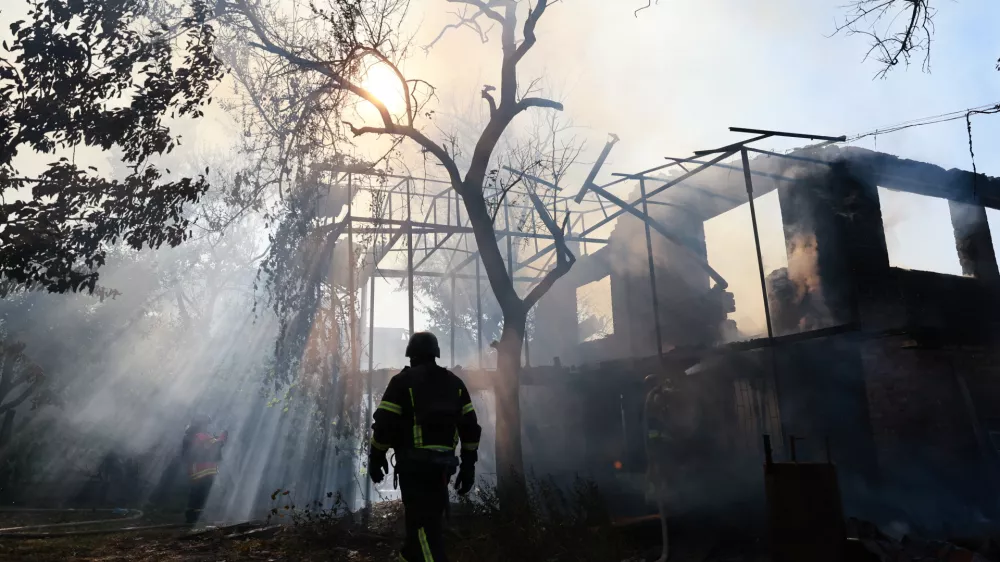 A firefighter puts out a fire after a Russian air guided bomb hit a private house in Zaporizhzhia, Ukraine, Thursday, July 16, 2026. (AP Photo/Kateryna Klochko)