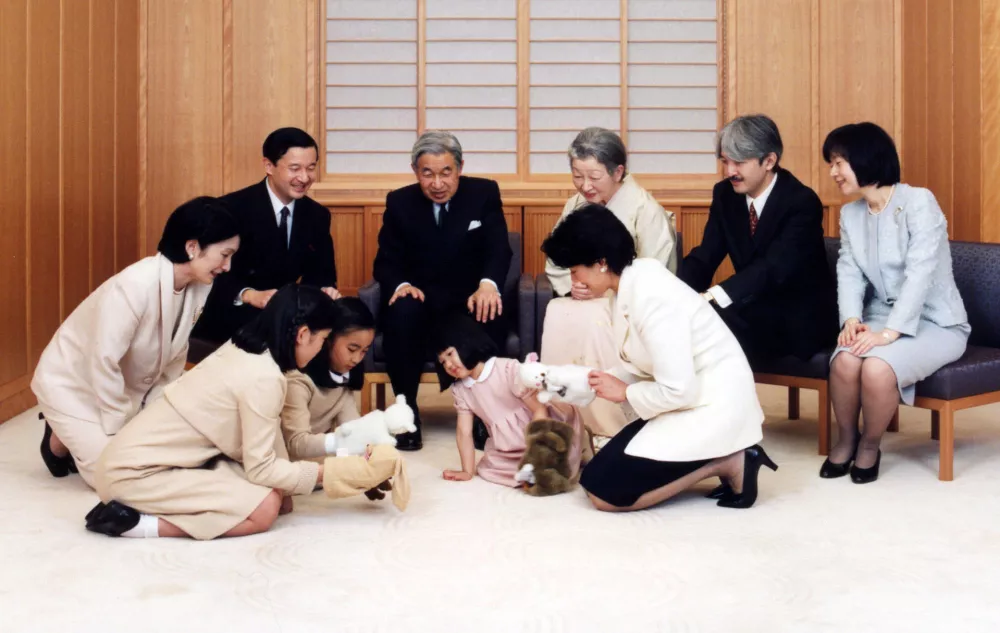 Japanese Emperor Akihito (C) and Empress Michiko (back 3rd R), and their family members look on Princess Aiko, daughter of Crown Prince Naruhito (back L) and Crown Princess Masako (front R) while Prince Aiko play with Princess Mako (front 2nd L) and Princess Kako (front 3rd L), daughters of Prince Akishino (back 2nd R) and Princess Kiko (front L), for a family photo session for the New Year at the Imperial Palace in Tokyo on this handout photograph taken December 14, 2004. Looking on at far right is Princess Sayako. Picture taken December 14, 2004. FOR EDITORIAL USE ONLY REUTERS/Imperial Household Agency/Handout IK/THI