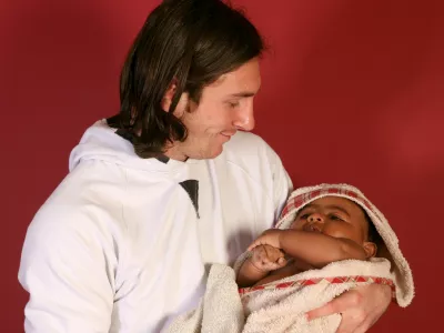 20-year-old soccer star Lionel Messi cradles Lamine Yamal, who was merely six months old at the time during a photo session in Sept. 2007 in the dressing room of the Camp Nou stadium in Barcelona, Spain. (AP Photo/Joan Monfort)