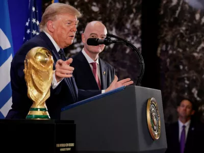 U.S. President Donald Trump, flanked by FIFA President Gianni Infantino, gestures while speaking next to FIFA World Cup Trophy, as they attend a FIFA reception at Trump Tower in New York City, U.S., July 17, 2026. REUTERS/Evan Vucci   TPX IMAGES OF THE DAY