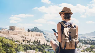 Young woman traveler using mobile phone outdoor