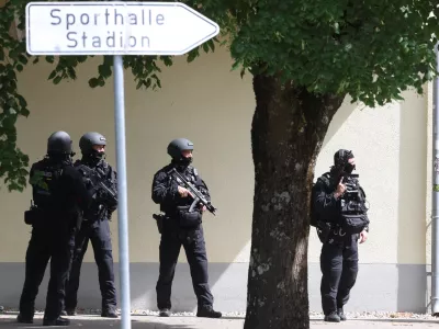 Heavily armed police officers guard at the Welfen High School, Schongau, Germany, Wednesday, July 8, 2026. (Karl-Josef Hildenbrand/dpa via AP)