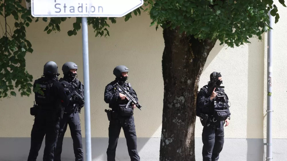 Heavily armed police officers guard at the Welfen High School, Schongau, Germany, Wednesday, July 8, 2026. (Karl-Josef Hildenbrand/dpa via AP)