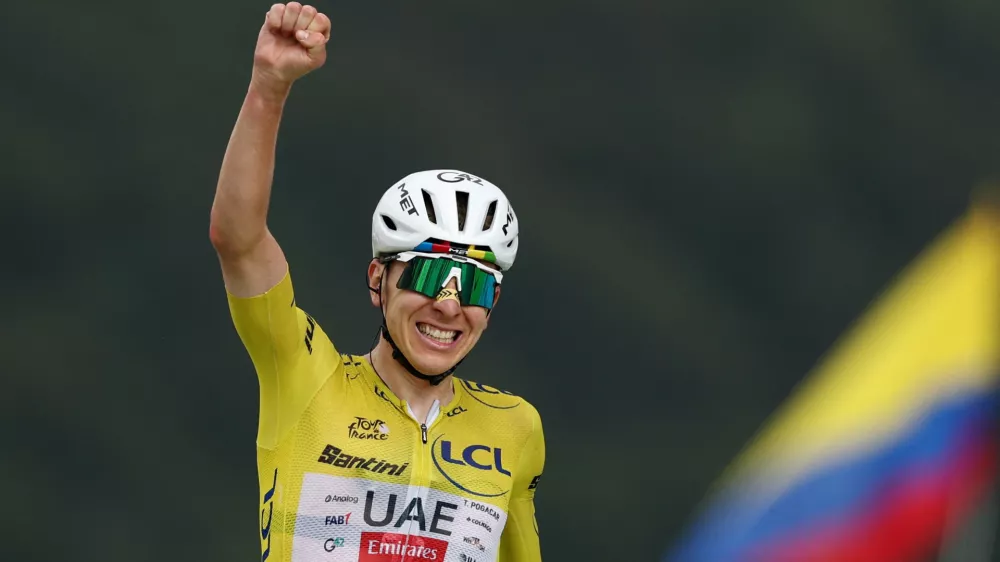 Cycling - Tour de France - Stage 14 - Mulhouse to Le Markstein Fellering - Le Markstein Fellering, France - July 18, 2026 UAE Team Emirates XRG's Tadej Pogacar, wearing the yellow jersey, celebrates after winning stage 14 REUTERS/Gonzalo Fuentes
