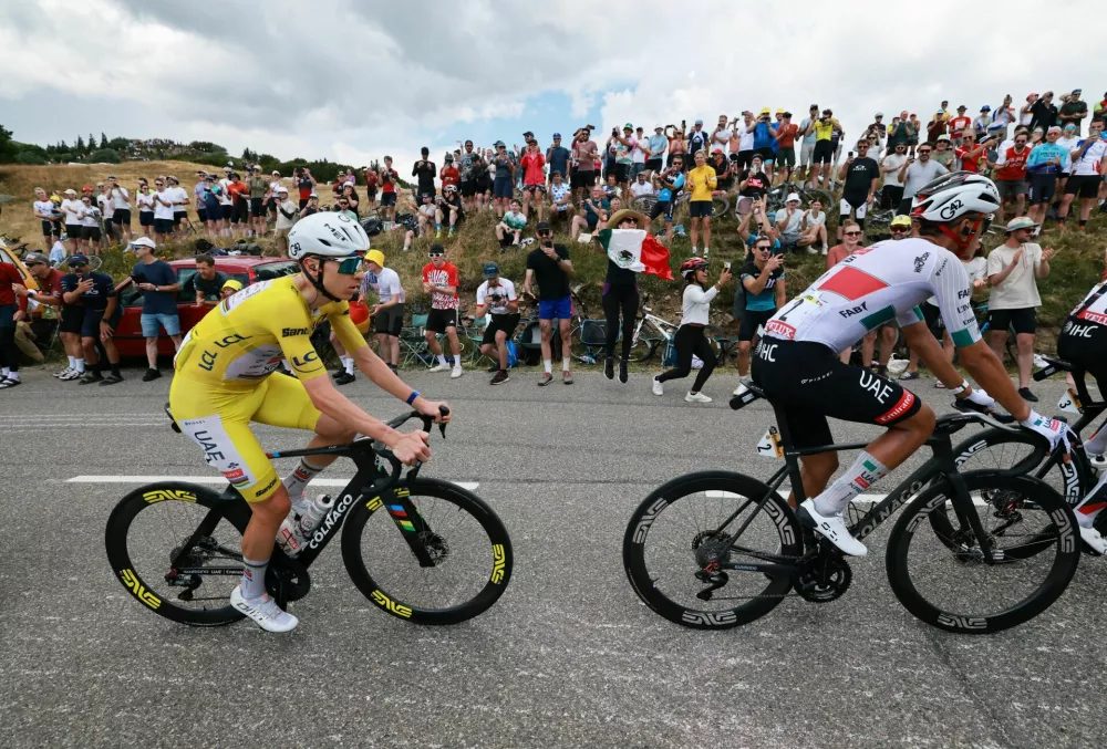 Cycling - Tour de France - Stage 14 - Mulhouse to Le Markstein Fellering - Mulhouse, France - July 18, 2026 UAE Team Emirates XRG's Tadej Pogacar, wearing the yellow jersey, and UAE Team Emirates XRG's Isaac Del Toro in action during stage 14 REUTERS/Stephanie Lecocq