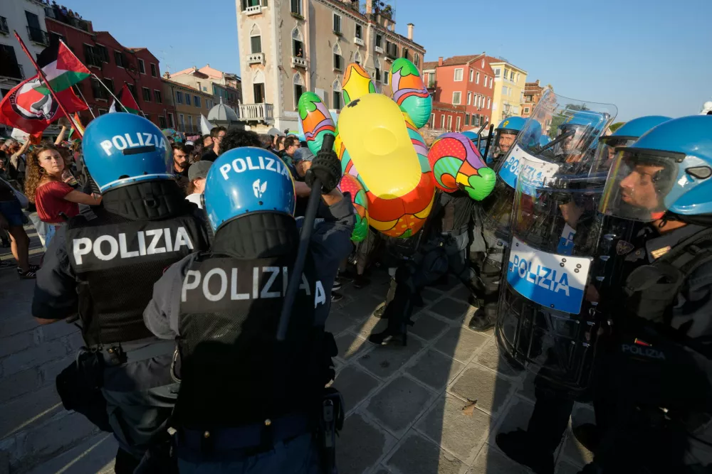 Police officers confront demonstrators gathered to protest against U.S. Ambassador Tilman Fertitta's luxury yacht 'Boardwalk" presence in Venice, Friday, July 17, 2026. (AP Photo/Luca Bruno)