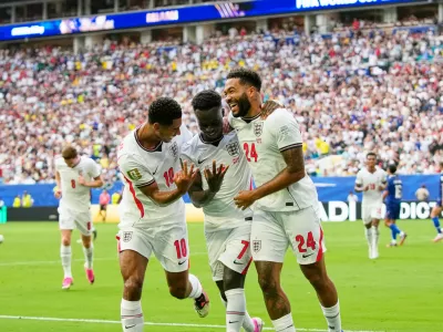 England's Bukayo Saka (7) celebrates with Jude Bellingham (10) and Reece James (24) after scoring their fifth goal, his third, during the World Cup third-place playoff soccer match between France and England in Miami Gardens, Fla., Saturday, July 18, 2026. (AP Photo/Lynne Sladky)