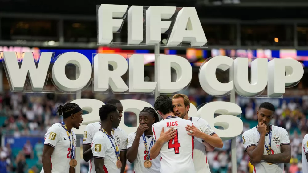 England's Harry Kane (9) embraces Declan Rice during the presentation after the World Cup third-place playoff soccer match between France and England in Miami Gardens, Fla., Saturday, July 18, 2026. (AP Photo/Rebecca Blackwell)