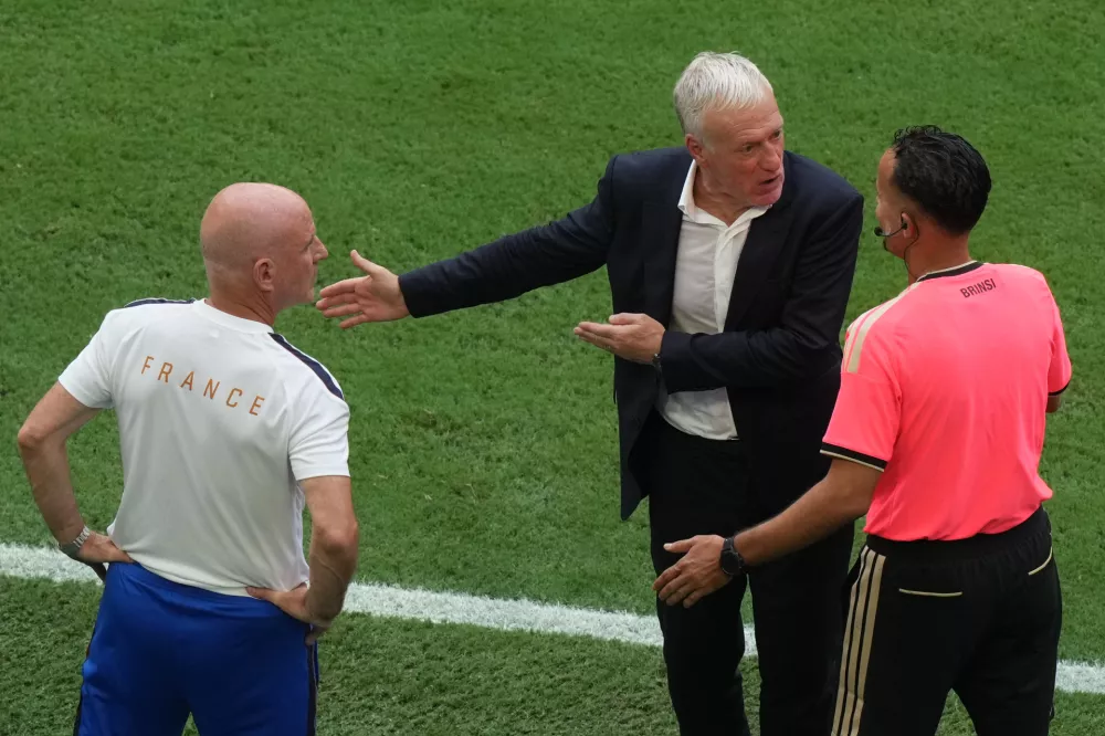 France head coach Didier Deschamps, center, talks to an official during the World Cup third-place playoff soccer match between France and England in Miami Gardens, Fla., Saturday, July 18, 2026. (AP Photo/Marta Lavandier)