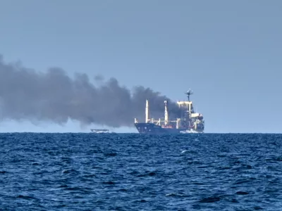 Smoke rises from the grain carrier Golden Leo&nbsp;under the Guinea-Bissau flag after Russian missile strike in the Black Sea close to Odesa, Ukraine, Sunday, July 19, 2026, local media reports. (AP Photo/Michael Shtekel)