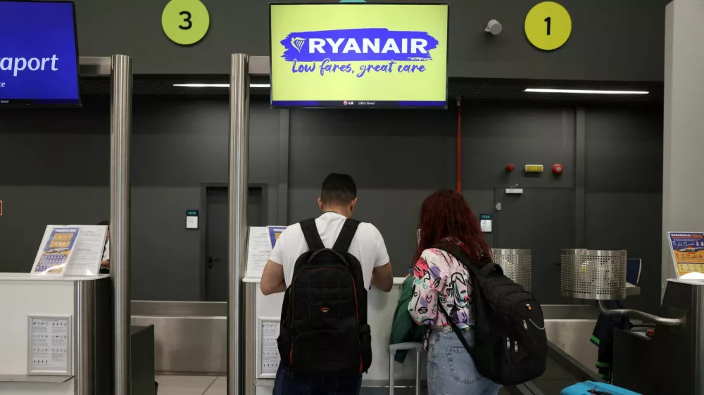 FILE PHOTO: People stand at Ryanair counter, inside the Makedonia airport in Thessaloniki, Greece, May 7, 2026. REUTERS/Alexandros Avramidis/File Photo