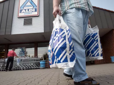 FILE - In this July 30, 2002 file photo a man carries two plastic bags in front of an ALDI market in Gelsenkirchen, Germany. German discount supermarket chain Aldi says Wednesday, July 28, 2010, Theo Albrecht, its co-founder and considered one of the country's richest men, has died. He was 88. (AP Photo / Martin Meissner, file)