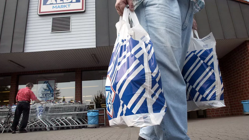 FILE - In this July 30, 2002 file photo a man carries two plastic bags in front of an ALDI market in Gelsenkirchen, Germany. German discount supermarket chain Aldi says Wednesday, July 28, 2010, Theo Albrecht, its co-founder and considered one of the country's richest men, has died. He was 88. (AP Photo / Martin Meissner, file)