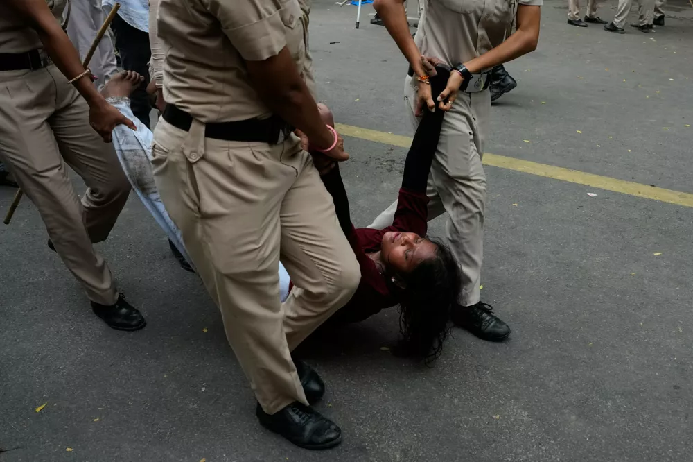 Police detains a supporter of the Cockroach Janta Party as they attempt to march toward India's Parliament, demanding the resignation of the education minister, in New Delhi, India, Monday, July 20, 2026.(AP Photo/Manish Swarup)