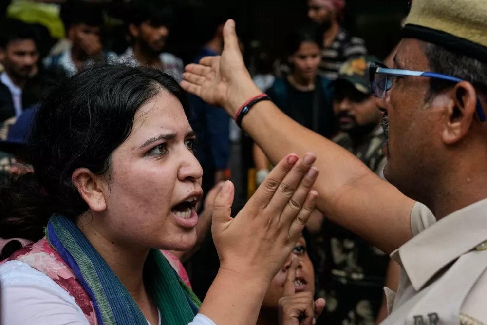 Supporters of the Cockroach Janta Party scuffle with police as they attempt to march toward India's Parliament, demanding the resignation of the education minister, in New Delhi, India, Monday, July 20, 2026. (AP Photo/Manish Swarup)