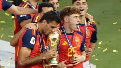 Spain's Rodri (16) kisses the trophy as Spain celebrates after winning the World Cup final soccer match between Spain and Argentina in East Rutherford, N.J., near New York, Sunday, July 19, 2026. (AP Photo/Adam Hunger)