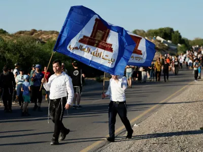 People march towards the Gaza Strip under the slogan "After 21 years, we're returning home", referring to Israel's unilateral withdrawal of around 8,500 Jewish settlers from the Gaza Strip in 2005, near Kibbutz Zikim and Israel's border with Gaza, in southern Israel, July 19, 2026. REUTERS/Amir Cohen
