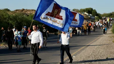 People march towards the Gaza Strip under the slogan "After 21 years, we're returning home", referring to Israel's unilateral withdrawal of around 8,500 Jewish settlers from the Gaza Strip in 2005, near Kibbutz Zikim and Israel's border with Gaza, in southern Israel, July 19, 2026. REUTERS/Amir Cohen