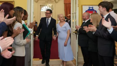 Staff clap as new Prime Minister Andy Burnham and wife Marie-France van Heel walk into 10 Downing Street in London, Monday, July 20, 2026. (AP Photo/Kin Cheung, Pool)