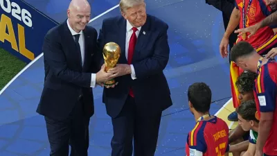 FIFA President Gianni Infantino and President Donald J. Trump present the trophy to Spain's Rodri (16) after the World Cup final soccer match between Spain and Argentina in East Rutherford, N.J., near New York, Sunday, July 19, 2026. (AP Photo/Matt Rourke)
