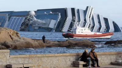 The cruise ship Costa Concordia lies on its side off the tiny Tuscan island of Giglio, Italy, Friday, Jan. 20, 2012. The 0 million Costa Concordia was carrying more than 4,200 passengers and crew when it slammed into well-marked rocks off the island of Giglio after the captain made an unauthorized diversion from his programmed route. The ship then keeled over on its side. (AP Photo/Gregorio Borgia)