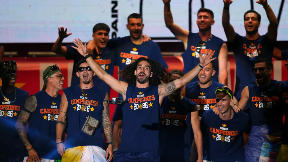 Spain's Marc Cucurella waves during celebrations with his national team teammates at Cibeles Square in Madrid on Monday, July 20, 2026, after Spain defeated Argentina in the World Cup final in East Rutherford, N.J., near New York. (AP Photo/Manu Fernandez)