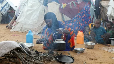 An internally displaced woman prepares breakfast outside their makeshift shelter during a visit by World Food Programme's Assistant Executive Director for Programme Operations, Matthew Hollingworth (not in the photo), to assess the knock on effects from the escalation in the Middle East, alongside drought and sharp cuts in humanitarian funding that are worsening hunger, in Kahda district of Mogadishu, Somalia May 7, 2026. REUTERS/Feisal Omar