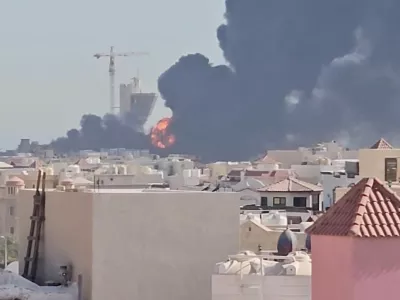 Smoke billows near the oil facility in Mangaf, Kuwait, July 18, 2026, in this screen grab obtained from a social media video. Social Media/via REUTERS THIS IMAGE HAS BEEN SUPPLIED BY A THIRD PARTY. MANDATORY CREDIT. NO RESALES. NO ARCHIVES. NEWS USE ONLY. Verification lines: - Tower, mosque, and buildings matched satellite and archive imagery. - Date verified by statement from Kuwait Petroleum Corporation that one of its oil facilities had been hit in "repeated Iranian attacks," causing significant damage and some injuries, according to the state news agency. - The area where the smoke is shown in the video is marked as a Kuwait Petroleum Company facility on Google maps.
