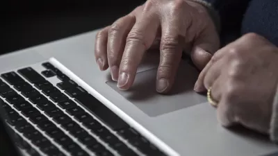 A cyber warfare expert works on his Apple laptop computer during a portrait session in Charlotte, North Carolina in this December 1, 2011 file photograph. Apple Inc was recently attacked by hackers who infected the Macintosh computers of some employees, the company said on February 19, 2013 in an unprecedented disclosure that described the widest known cyber attacks against Apple-made computers to date.    REUTERS/John Adkisson/Files   (UNITED STATES - Tags: CRIME SCIENCE TECHNOLOGY)