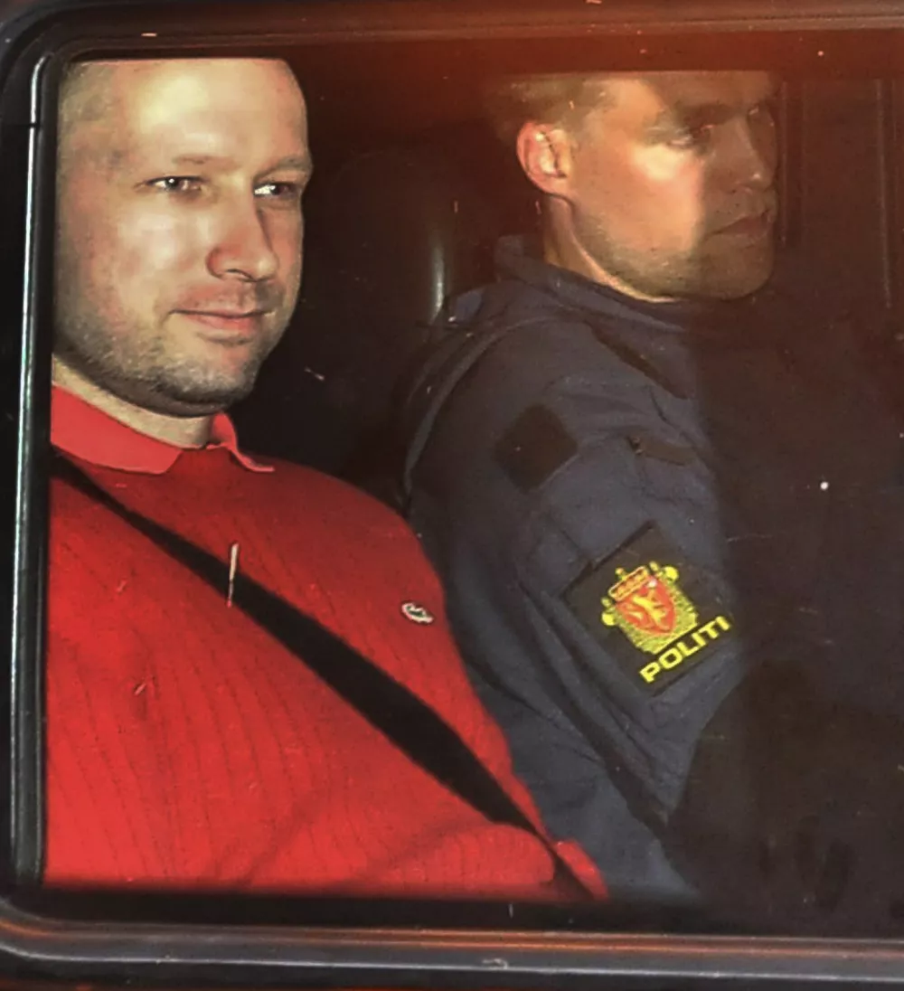 FILE - This is a Monday July 25, 2011 file photo of  Norway's twin terror attacks suspect Anders Behring Breivik, left, sits in an armored police vehicle after leaving the courthouse following a hearing in Oslo. Norwegian police say they will ask a court to extend the pretrial detention of confessed mass killer Anders Behring Breivik by eight weeks, four of them in isolation. The 32-year-old right-wing extremist will go before the Oslo District Court in a closed hearing Monday, Sept. 19. 2011 his third court appearance since the bombing in downtown Oslo and shooting massacre at a youth camp on Utoya island. Seventy-seven people died in the attacks. (AP Photo/Aftenposten/Jon-Are Berg-Jacobsen, File) NORWAY OUT