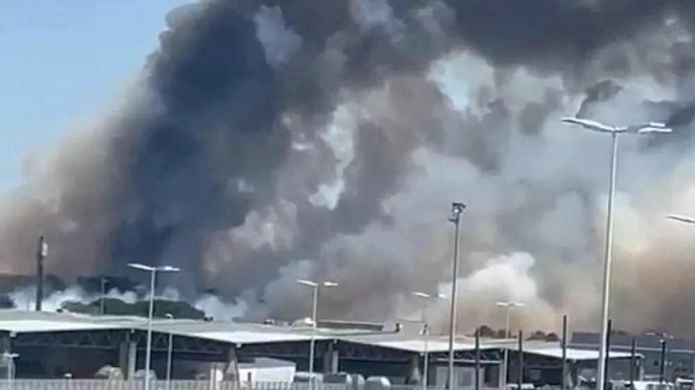 Smoke rises near the Bordeaux-Merignac Airport in France, July 21, 2026, in this screengrab obtained from a social media video. @hichem33600/via REUTERS THIS IMAGE HAS BEEN SUPPLIED BY A THIRD PARTY. MANDATORY CREDIT. NO RESALES. NO ARCHIVES. VERIFICATION: Reuters was able to verify the location through buildings, and light posts that matched satellite and archive imagery. Coordinates: 44.8311953, -0.7017427. The date was confirmed through original file metadata and corroborating media and eyewitness visuals that show the fire near the airport. Local media reported the fire broke out near the Bordeaux-Merignac Airport in France on July 21