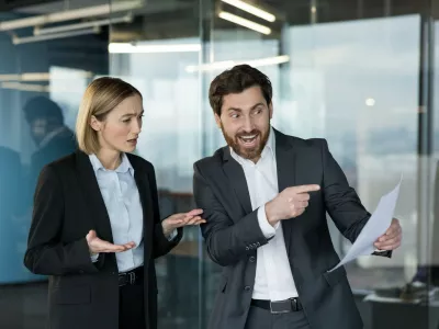 Business colleagues in an office workspace having a heated discussion about a report, showing conflict, misunderstanding, and stress in a professional environment,Image: 1106862010, License: Royalty-free, Restrictions:, Model Release: yes 