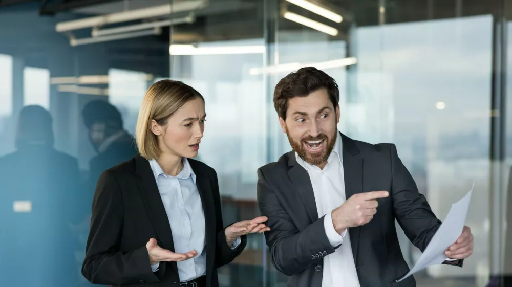 Business colleagues in an office workspace having a heated discussion about a report, showing conflict, misunderstanding, and stress in a professional environment,Image: 1106862010, License: Royalty-free, Restrictions:, Model Release: yes 