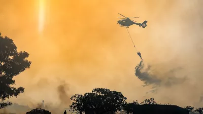 Firefighters use a helicopter to combat wildfires in Rome on Tuesday, July 21, 2026, after a fire broke out that, due to strong winds, quickly spread throughout the Acquafredda Nature Reserve. (Francesco Benvenuti/LaPresse via AP)