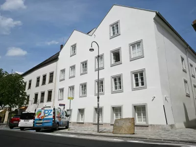 Vehicles are parked outside the building where Adolf Hitler was born, which has been converted into a police station by Austria's government in hopes of preventing it from serving as a place of &zwnj;pilgrimage for neo-Nazis, in Braunau am Inn, Austria, July 16, 2026. REUTERS/Angelika Warmuth