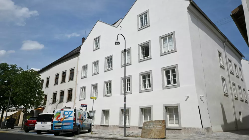 Vehicles are parked outside the building where Adolf Hitler was born, which has been converted into a police station by Austria's government in hopes of preventing it from serving as a place of &zwnj;pilgrimage for neo-Nazis, in Braunau am Inn, Austria, July 16, 2026. REUTERS/Angelika Warmuth