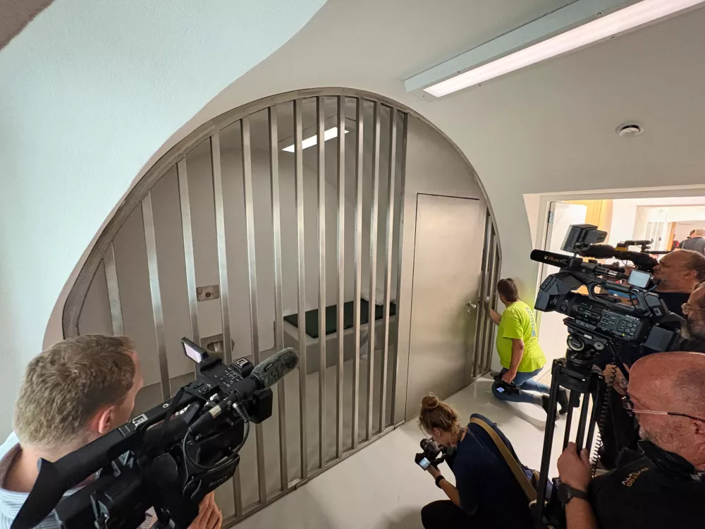 Media take pictures of a prison cell in a new police station which is located in Adolf Hitler's birth house in Braunau am Inn, Austria, Wednesday, July 22, 2026. (AP Photo/Matthias Schrader)