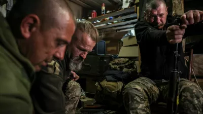 Serhii Krynitskyi, 42, a serviceman of the 24th Separate Mechanized Brigade of the Ukrainian Armed Forces, who spent 346 days at an isolated frontline position in the town of Chasiv Yar, Donetsk region, cleans an AK assault rifle on his first day back on duty after recovery, amid Russia's attack on Ukraine, in the frontline city of Kramatorsk in Donetsk region, Ukraine, May 27, 2026. REUTERS/Alina Smutko