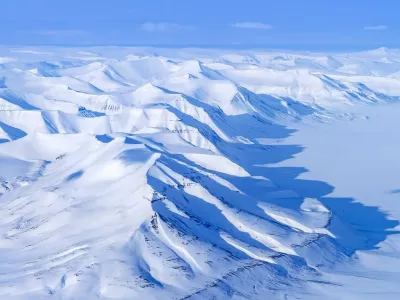 Aerial view over snow-covered mountains and valleys on Svalbard / Spitsbergen in spring, Norway.,Image: 1104268166, License: Rights-managed, Restrictions:, Model Release: no 