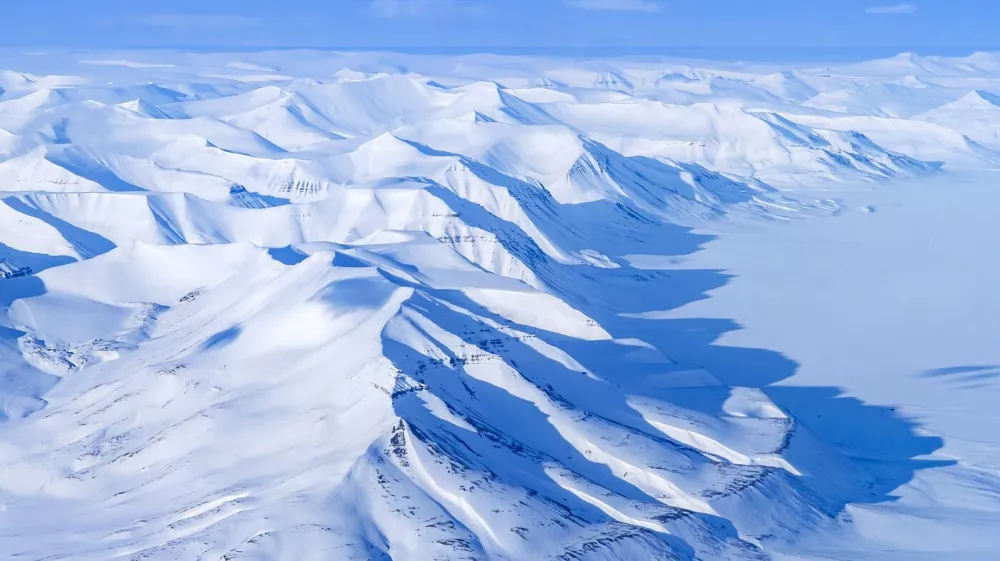 Aerial view over snow-covered mountains and valleys on Svalbard / Spitsbergen in spring, Norway.,Image: 1104268166, License: Rights-managed, Restrictions:, Model Release: no 