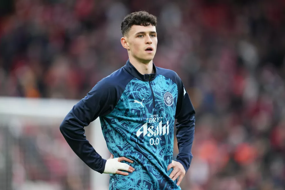FILE - Manchester City's Phil Foden warms up for the English Premier League soccer match between Liverpool and Manchester City in Liverpool, England, on Feb. 8, 2026. (AP Photo/Jon Super, File)