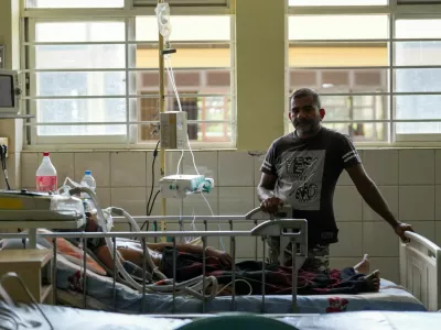 A dengue patient lies on the hospital bed while his son stands next to him at District General Hospital in Negombo, Sri Lanka, July 16, 2026. REUTERS/ Thilina Kaluthotage