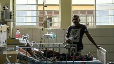 A dengue patient lies on the hospital bed while his son stands next to him at District General Hospital in Negombo, Sri Lanka, July 16, 2026. REUTERS/ Thilina Kaluthotage