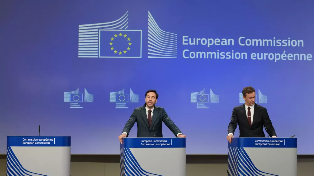 European Commission spokesman Thomas Regnier, left, speaks during a media conference regarding a fine against Google at EU headquarters in Brussels, Thursday, July 23, 2026. (AP Photo/Virginia Mayo)