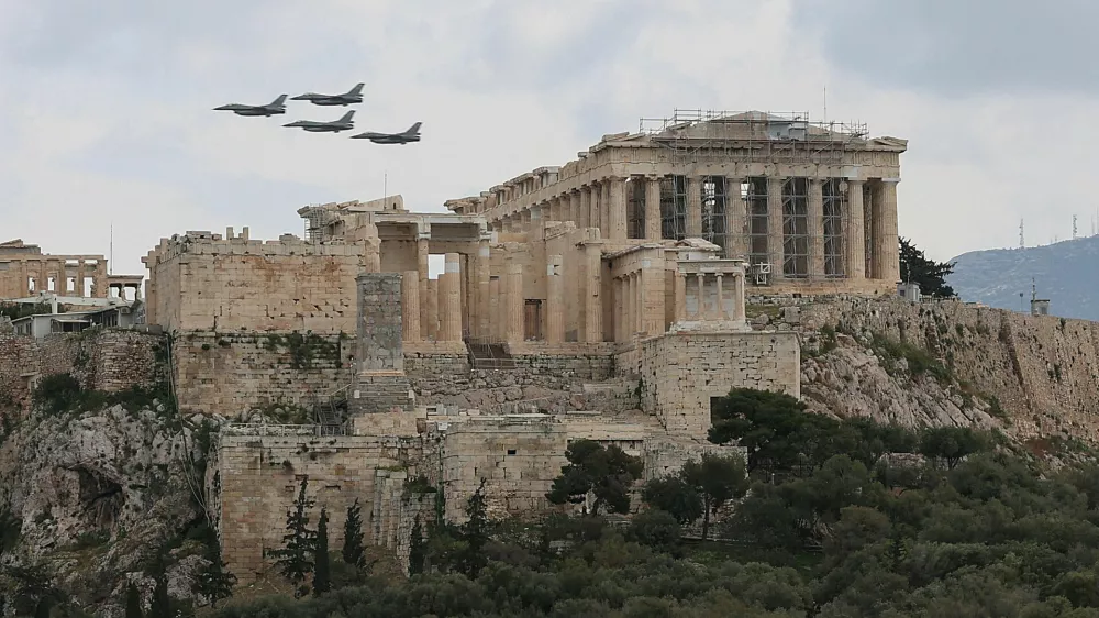 FILE PHOTO: Military planes fly above the Acropolis of Athens, as part of a military parade marking the country's Independence Day, in Athens, Greece, March 25, 2026. REUTERS/Louisa Gouliamaki/File Photo