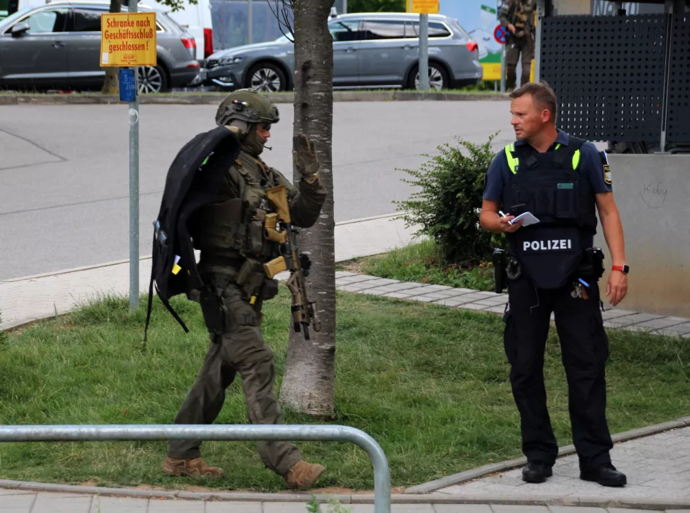 Special police walks towards a suspected hostage-taking situation in a bank in Regensburg, Germany, July 23, 2026.  REUTERS/Mario Moller
