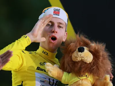 Cycling - Tour de France - Stage 21 - Paris, France - July 26, 2026 UAE Team Emirates XRG's Tadej Pogacar celebrates on the podium while wearing the yellow jersey after winning the Tour de France REUTERS/Stephanie Lecocq   TPX IMAGES OF THE DAY