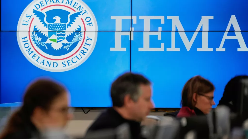 FILE - People work at the Federal Emergency Management Agency headquarters in Washington, Jan. 24, 2026. (AP Photo/Julia Demaree Nikhinson, File)